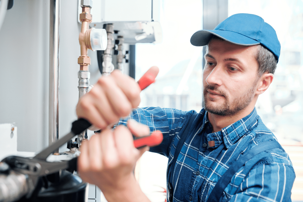 man repairing house pipes