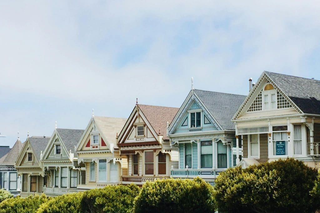 Fairly similar houses next to each other, each being a different color.